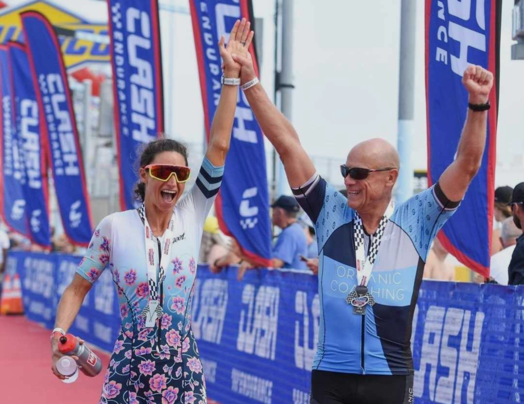 man and woman crossing triathlon finishline