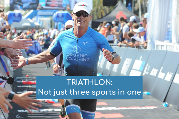 Man running down triathlon finish line