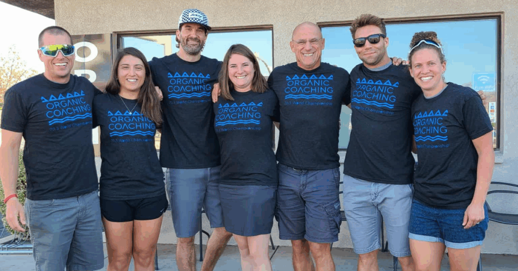 group of triathletes smiling before a race