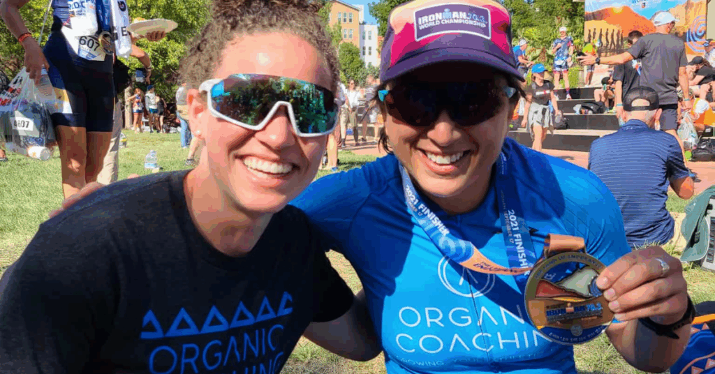 lady after triathlon race smiling with her coach
