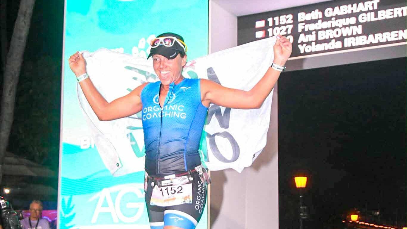 women crossing ironman finishline