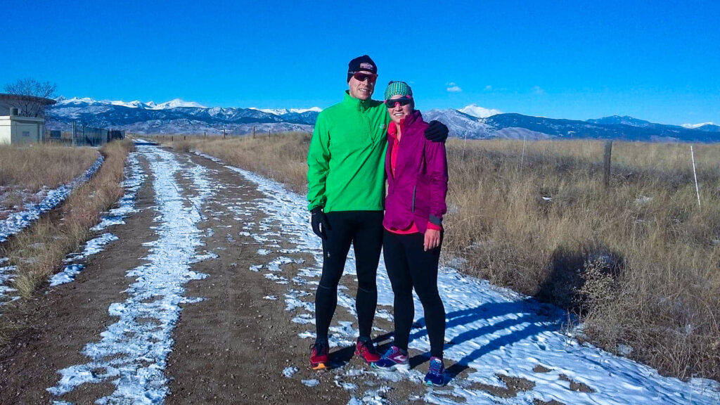 Man and woman taking a picture in running clothes in the winter