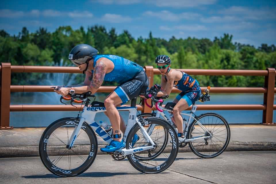 man riding triathlon bike in an ironman race