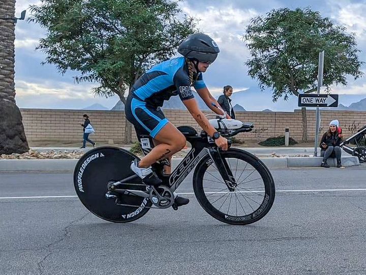 woman riding triathlon bike in a triathlon race