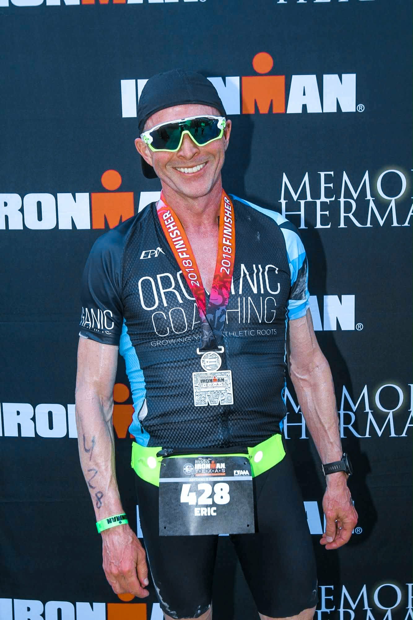 man at the finish of an Ironman triathlon